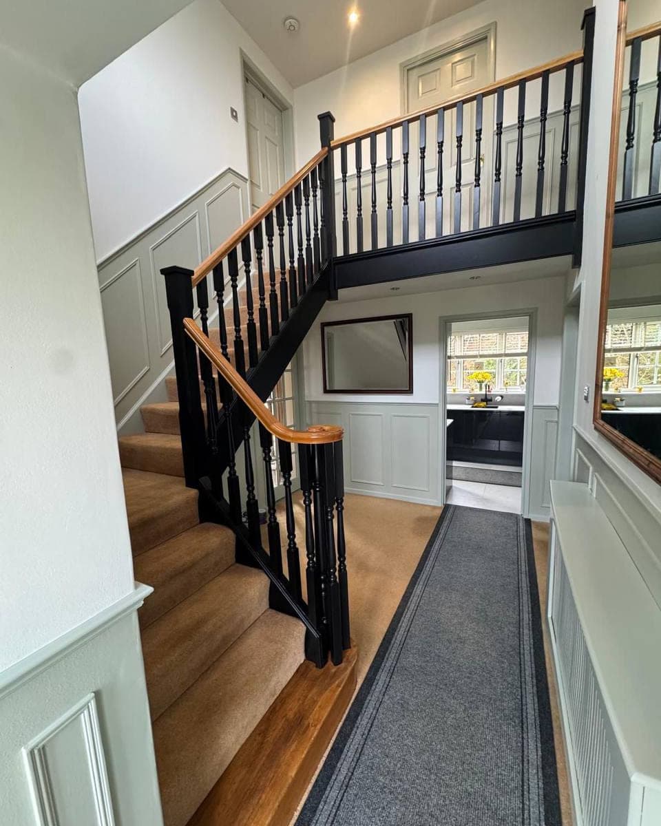 A hallway and landing with the spindles, newel posts, panelling and architrave all cut in by hand