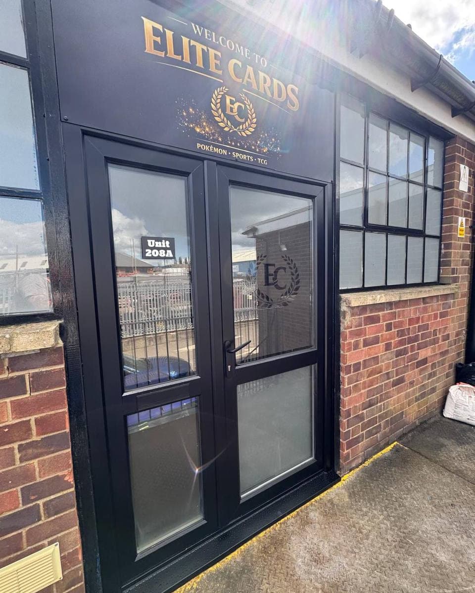 A commercial unit entrance with the doors and windows sprayed black